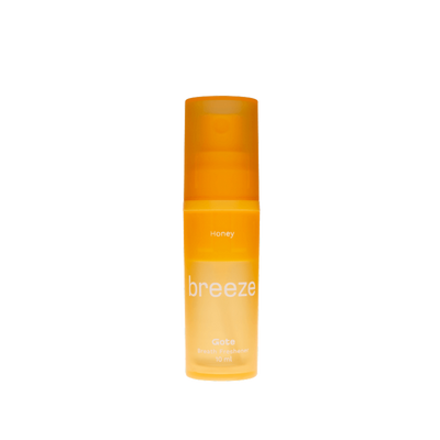 Orange bottle labeled 'breeze' on a white background