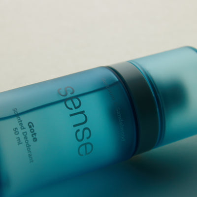 Blue deodorant bottle with 'sense' branding on a light background